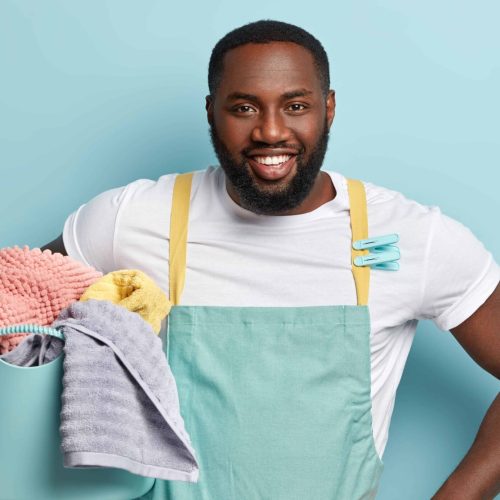 young-african-american-man-doing-laundry young-african-american-man-doing-laundry